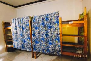 a wall with a blue and white pattern on it at La Vida Hostel in Puerto Princesa City