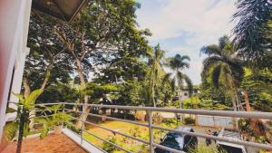a balcony of a resort with palm trees at La Vida Hostel in Puerto Princesa City