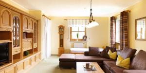 a living room with a couch and a table at Landhaus Riedl in Bad Füssing