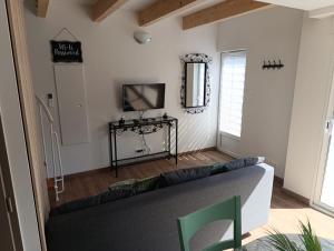 un salon avec un canapé et une télévision dans l'établissement Maison Duplex, à Pierrelatte