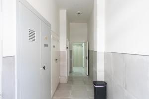 a hallway with white walls and a hallway with a door at MalagaSuite Comfortable Home Apartments in Málaga +41 photos