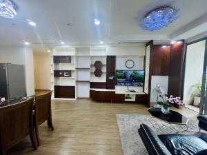 a living room with a couch and a television at BOM HOMES- Vinhomes Timescity-3Br-Luxury Apt in Hanoi