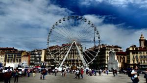 a large ferris wheel in the middle of a city at Hôtel Beauséjour in Marseille