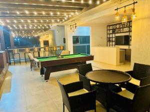 a billiard room with a pool table and chairs at Cheryl 233 Boulevard in Accra