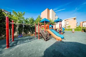 a playground with a slide in a park at Sunny beach family apartment 302, Sluneční pobřeží in Sunny Beach