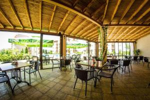 a dining room with tables and chairs and windows at Sunny beach family apartment 302, Sluneční pobřeží in Sunny Beach