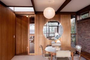 a dining room with a table and a mirror at The Bends House in Sandy Bay