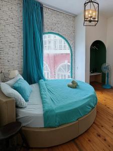 a bed with a blue canopy in a room at D Home Da Lat 4 in Da Lat