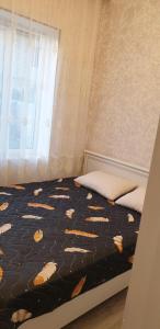 a bedroom with a bed and a window at Forest House-Lerik in Lerik +1 photo
