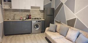 a living room with a couch and a kitchen at Forest House-Lerik in Lerik