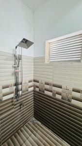 a shower in a bathroom with a window at Sunrise City Bliss in Sri Jayewardenepura Kotte