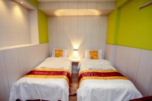 Postel nebo postele na pokoji v ubytování Hotel Pomelo House Inn