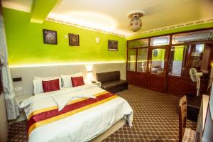 Postel nebo postele na pokoji v ubytování Hotel Pomelo House Inn