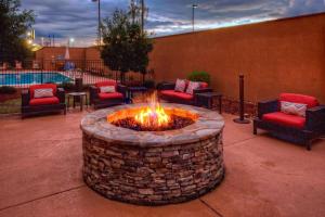 a fire pit in a patio with chairs and tables at Courtyard by Marriott Alexandria in Alexandria