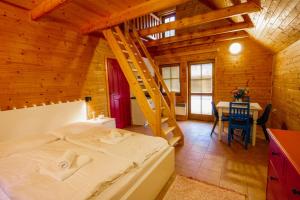 a bedroom with a bed in a wooden cabin at Chalets & Apartments - Base Camp Medvědín in Špindlerův Mlýn