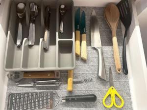 een lade vol keukengerei op een aanrecht bij Uliha street sea side apartment in Liepāja