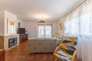 a living room with a couch and a fireplace at Casa Rural Arbana in Segovia