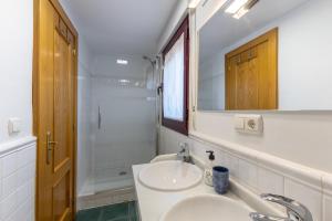 a white bathroom with a sink and a shower at Casa Rural Arbana in Segovia +24 photos