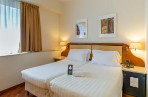 Postel nebo postele na pokoji v ubytování B&B Hotel Firenze Pitti Palace al Ponte Vecchio