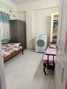 a room with a bedroom with a bed and a fan at Welcome to our Charming house in Visakhapatnam +10 photos