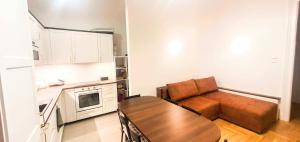 a kitchen with a couch and a table in a room at Ó 38 Family Luxe in Budapest +4 photos