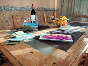 a table with a bottle of wine and a plate of food at APARTAMENTOS La PEÑA D in La Guancha +7 photos