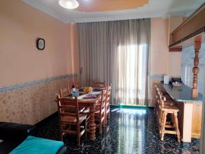 a kitchen and dining room with a table and chairs at APARTAMENTOS La PEÑA D in La Guancha