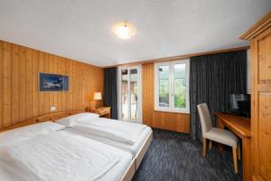 Letto o letti in una camera di Jungfrau Lodge, Swiss Mountain Hotel