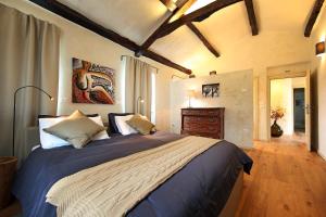 a bedroom with a large bed in a room at Villa Benvenuti near Motovun for 8 people - pet friendly with salt - water pool in Kaldir