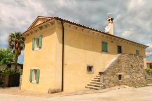 a building with a chimney on top of it at Villa Benvenuti near Motovun for 8 people - pet friendly with salt - water pool in Kaldir