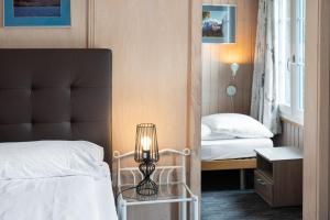 Letto o letti in una camera di Jungfrau Lodge, Swiss Mountain Hotel