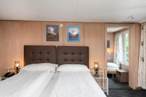 Letto o letti in una camera di Jungfrau Lodge, Swiss Mountain Hotel