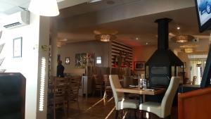 a restaurant with a wood stove in the dining room at Best overnight modern & private with King size bed in Bloemfontein