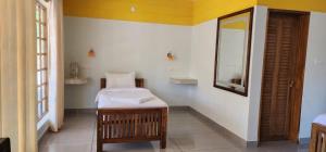 A bed or beds in a room at Magnolia Guesthouse Varkala