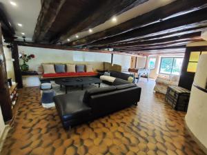 a living room with a couch and a table at Au Jardin Des Clefs in Autrans +13 photos