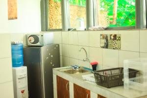 a kitchen with a sink and a refrigerator at Raica enterprises in Nyali