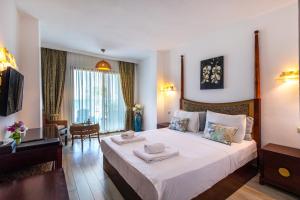a bedroom with a large bed with towels on it at Hotel Ekincik in Ekincik