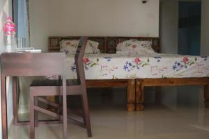 A bed or beds in a room at Magnolia Guesthouse Varkala