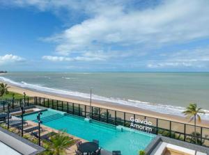 a view of the beach from the balcony of a condo at Beach Haus beira mar bessa in Tambaú
