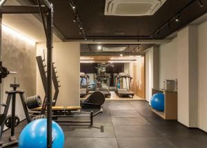 a gym with treadmills and exercise equipment in a room at Beach Haus beira mar bessa in Tambaú