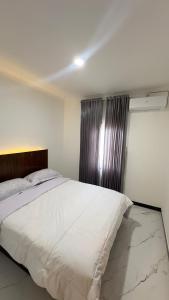 Ένα ή περισσότερα κρεβάτια σε δωμάτιο στο Abram Homestay - For Family and Friends