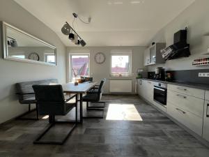 a kitchen with a table and chairs in a room at Mein Quartier am Harz in Herzberg am Harz