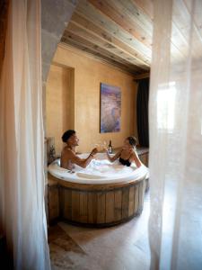 a man and a woman in a bath tub at Breeze Of Cappadocia in Uchisar