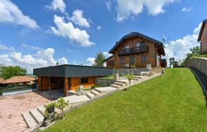 a house with a green lawn in front of it at Vineyard Dream Villa in Vinogradi Ludbreski in Vinogradi Ludbreški
