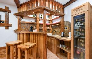 a bar in a log cabin kitchen with wooden cabinetry at Vineyard Dream Villa in Vinogradi Ludbreski in Vinogradi Ludbreški