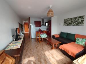 a living room with a couch and a table at Casa Sauce in Puerto del Carmen