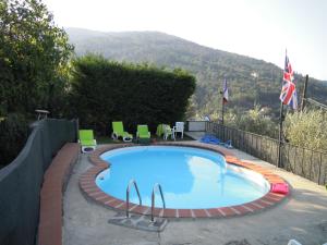 a large swimming pool with chairs and a fence at Holiday Home Bel Panorama Due in Pelago