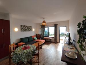 a living room with a couch and a table at Casa Sauce in Puerto del Carmen