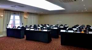 a conference room with tables and chairs in it at Protea Hotel by Marriott Nelspruit in Nelspruit