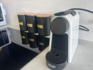 a toaster sitting on top of a counter with a stack ofools at Central CBD - parking - sleeps 4 in Canberra